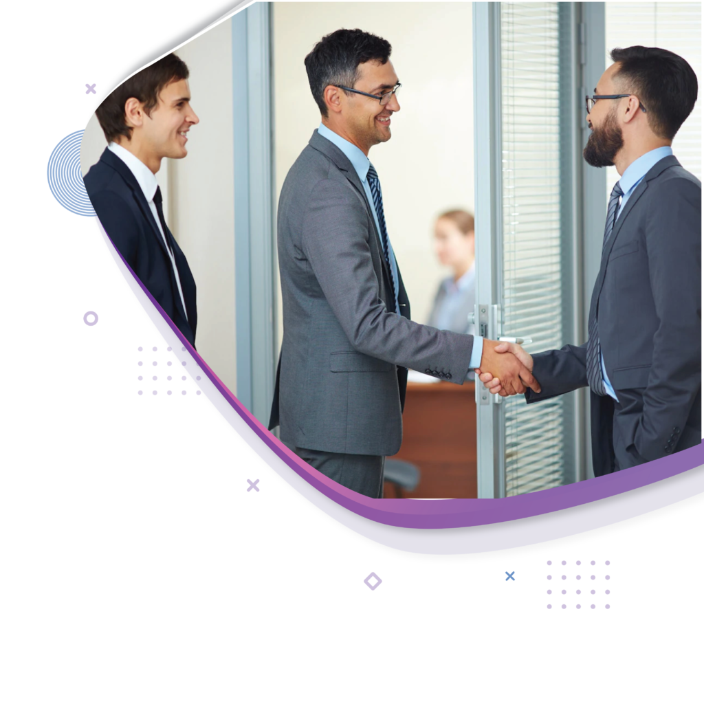 Two men shaking hands in a professional office setting.