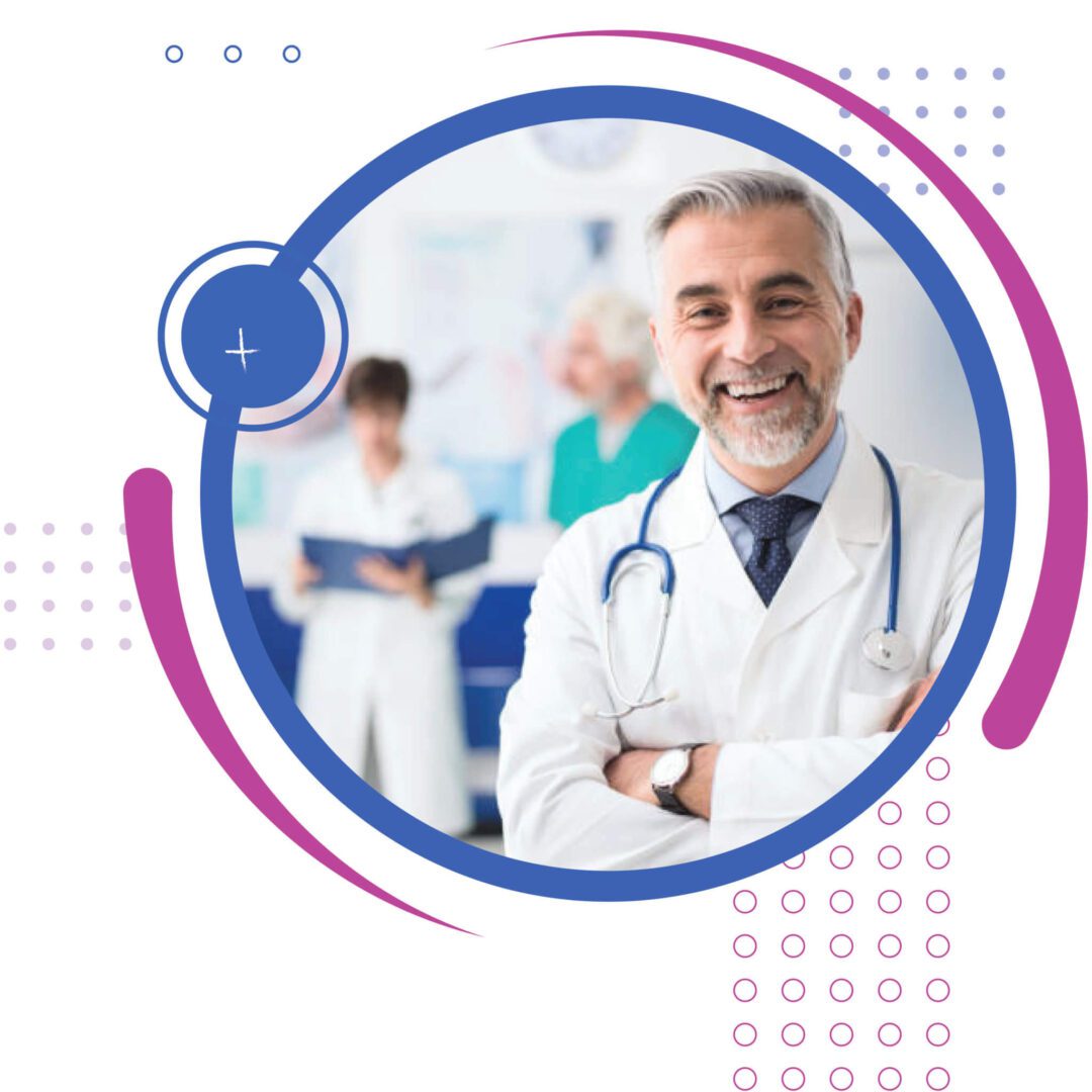 Smiling male doctor with stethoscope, medical team blurred in background.